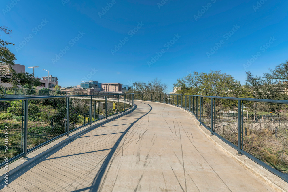 Bike path at the Waterloo park in Austin Texas against blue sky on a sunny day