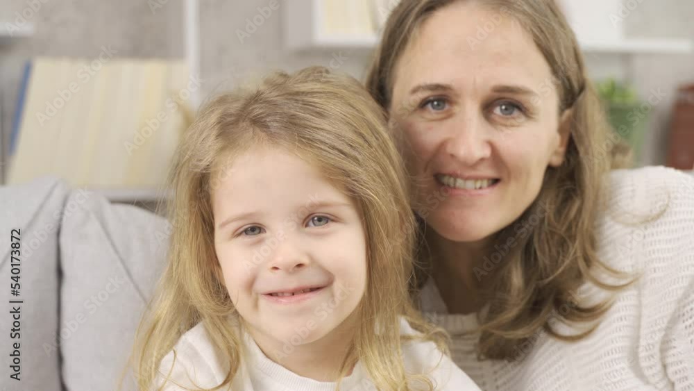 Mother and daughter smiling and looking at camera.
Happy mother and daughter look at camera.
Mother and daughter smiling and looking at camera.
Happy mother and daughter look at camera.