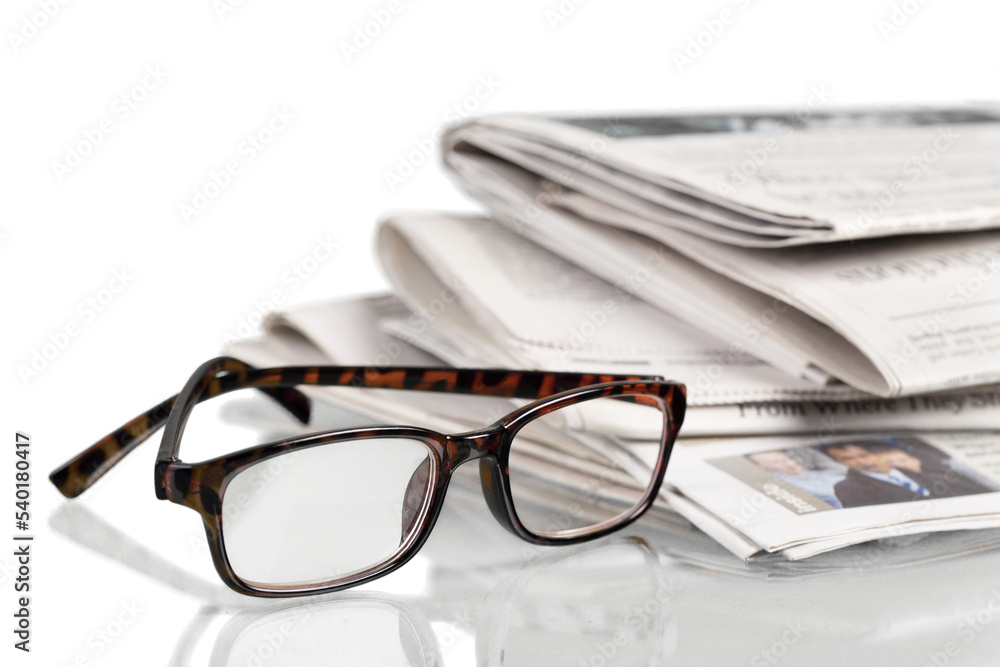 Closeup of Newspapers with Eyeglasses