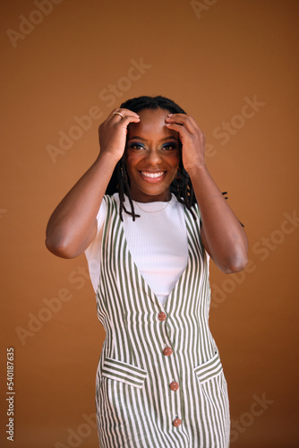 Studio portrait of young beautiful woman with dreads photo