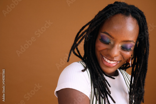 Studio portrait of young beautiful woman with dreads