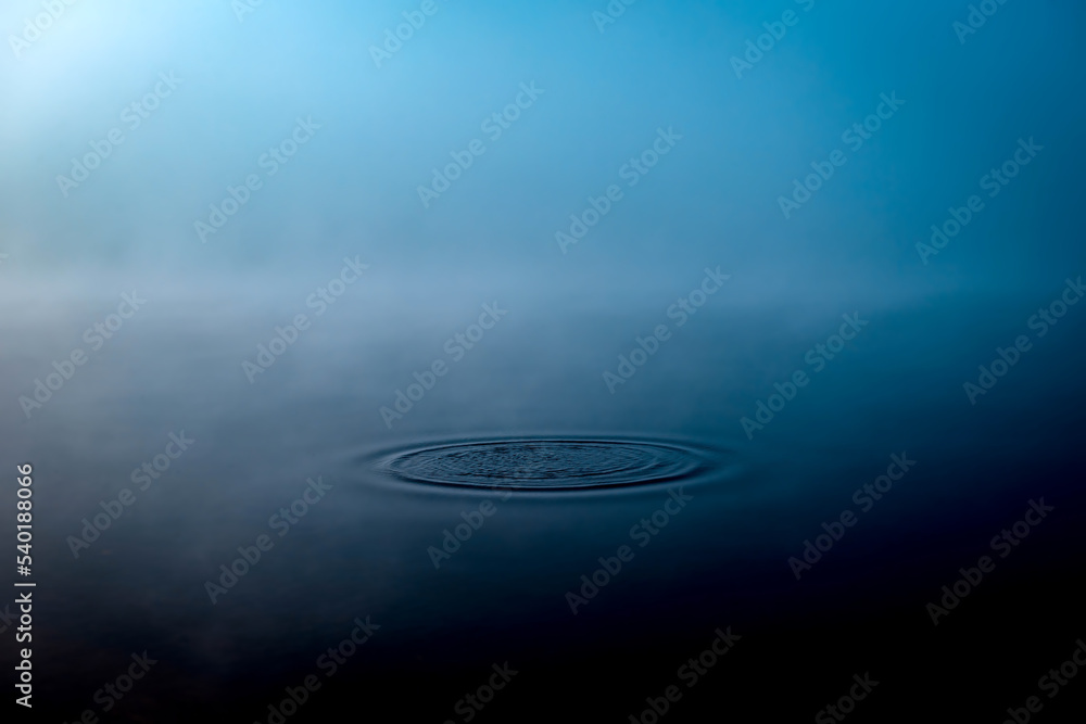Thick morning fog on the lake or river. Circles on the water. Relaxation and meditation banner. Thick morning fog on the lake or river. Circles on the water. Relaxation and meditation banner.