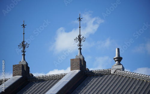 Lightning rod on roof of building on a clear blue sky day