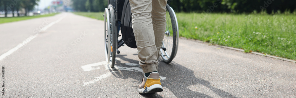 Obraz premium Man drive person in wheelchair, friend visit someone in nursing house