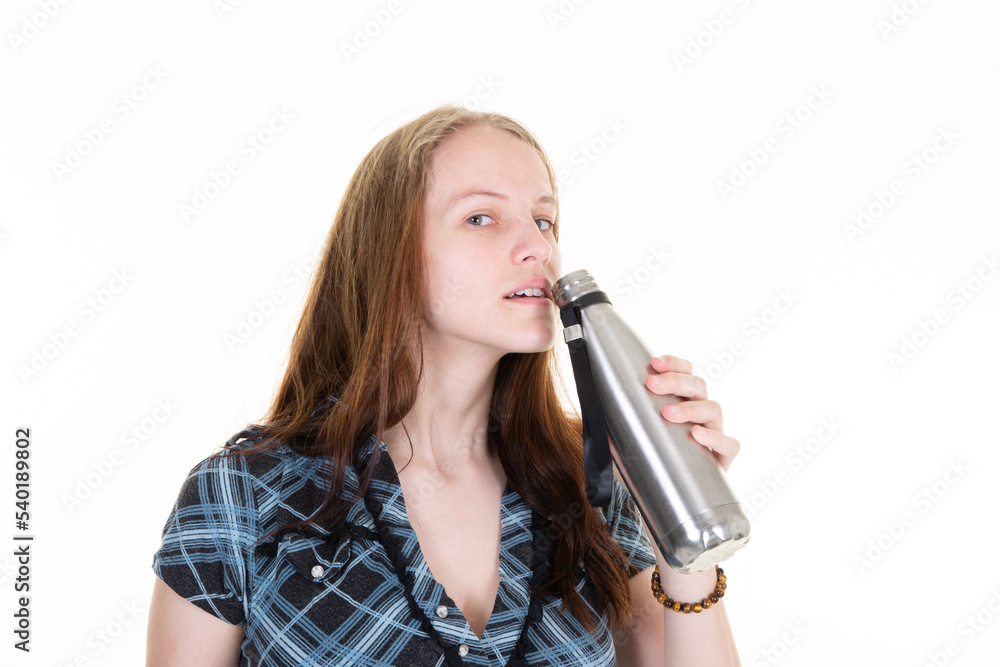 woman drinks water with a metallic thermos flask in her hand woman drinks water with a metallic thermos flask in her hand