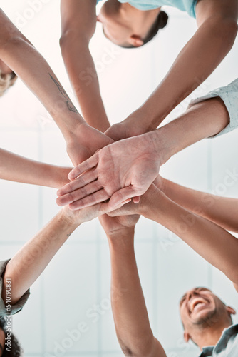Hands, collaboration and unity with a business team in a huddle or circle in the office together from below. Meeting, success and motivation with a man and woman group standing in solidarity