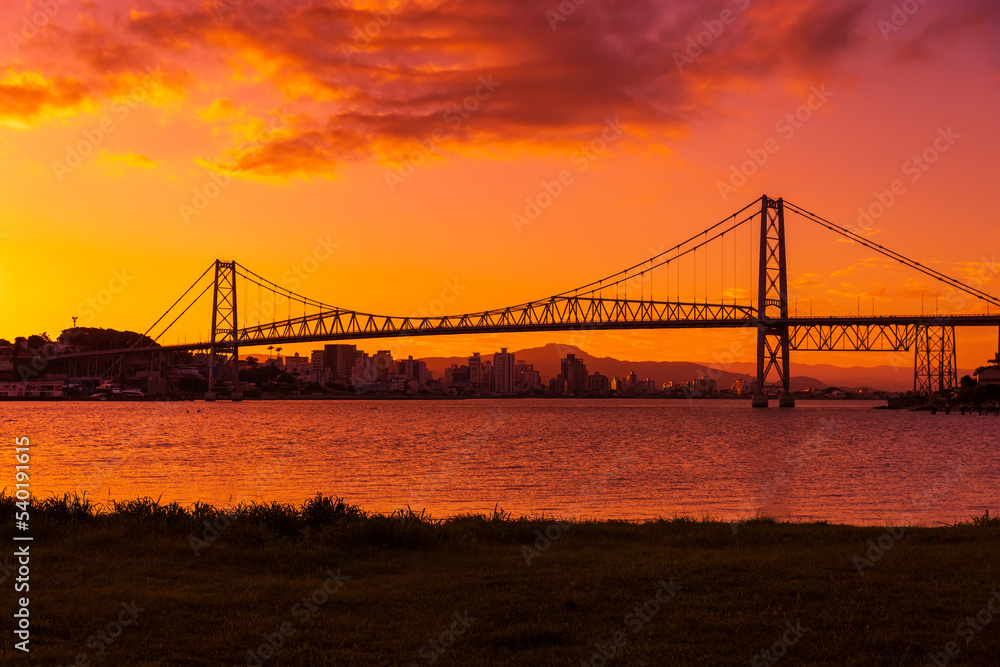 Cable bridge with sunset sky and reflection on water in Florianopolis, Brazil Cable bridge with sunset sky and reflection on water in Florianopolis, Brazil