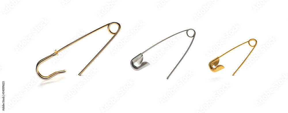 Set of safety pins isolated on white background. Gold and silver pins Set of safety pins isolated on white background. Gold and silver pins