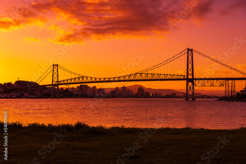 Cable bridge with sunset sky and reflection on water in Florianopolis, Brazil