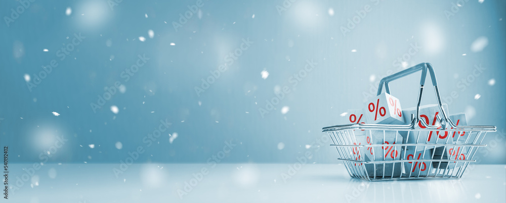 Winter Sale. Shopping basket and red percentage sign and snow effect, Christmas shopping background. Christmas and New year sale concept. wide web banner. copy space