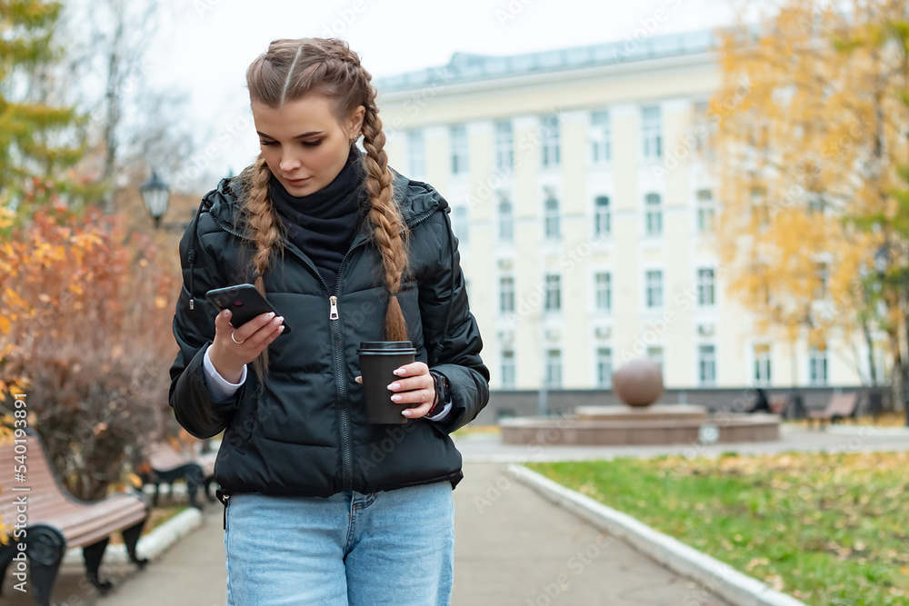 The girl goes and corresponds with someone on the phone. The girl goes and corresponds with someone on the phone.