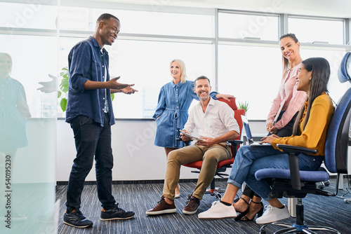 Photography Businessman leading meeting with work colleagues in startup office explaining bu