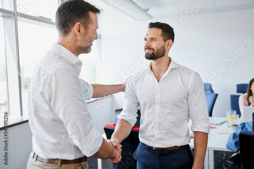Onboarding concept. Manager welcomes  new employee to the company. Boss congratulates on promotion photo