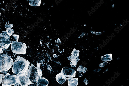 Ice cubes crush on black background. Chill backdrop.