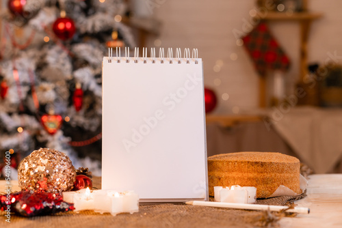 a notebook with empty pages on a wooden table with coffee and homemade honey cake. A notebook for recipes, cooking at home. Homemade cakes