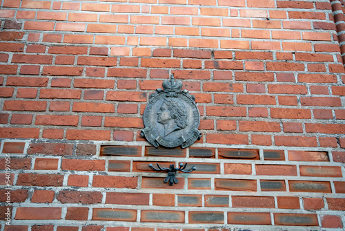 A memorial sign about the stay of Peter I in Koenigsberg on the brick wall of the Cathedral. Kaliningrad. Russia October 2022 photo