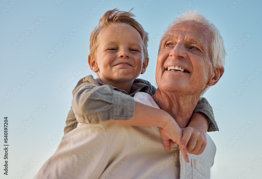 Fototapeta premium Piggyback, child and grandfather with smile in nature for freedom, love and relax with a blue sky. Portrait of a young, happy and playful kid being funny, bonding and crazy with a senior man in park