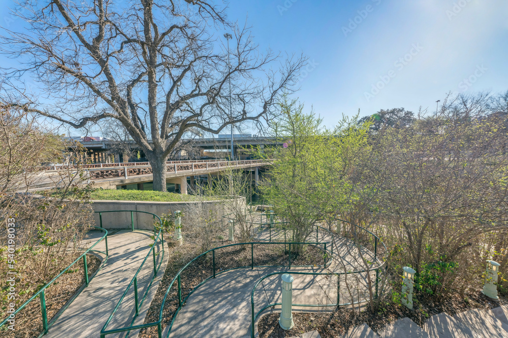 San Antonio, Texas- High angle view of concrete pathway with handrails near the bridge at River Walk