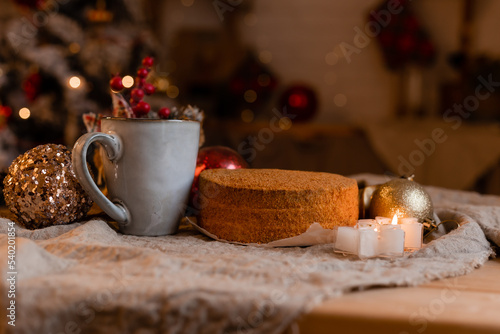 coffee in a designer mug and homemade honey cake on a wooden table in a New Year atmosphere. cozy christmas, cozy winter. High quality photo