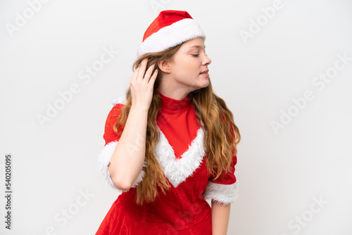 Young caucasian woman with Christmas dress isolated on white background listening to something by putting hand on the ear
