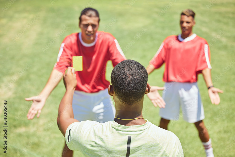 Obraz premium Soccer, team and referee with yellow card, booking and foul a player on a grass pitch or field during a game. Fitness, football and discipline with a man ref giving a caution during a sports match