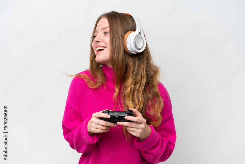 Young pretty woman playing with a video game controller isolated on white background laughing in lateral position Young pretty woman playing with a video game controller isolated on white background laughing in lateral position
