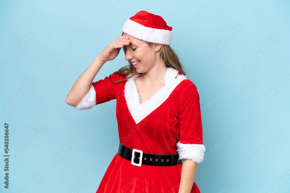 Young blonde woman dressed as mama claus isolated on blue background laughing Young blonde woman dressed as mama claus isolated on blue background laughing