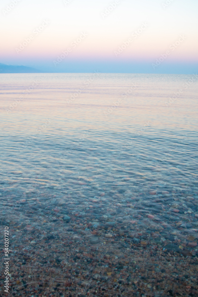 The surface of the water in the Issyk Kul mountain lake in Kyrgyzstan at sunset
