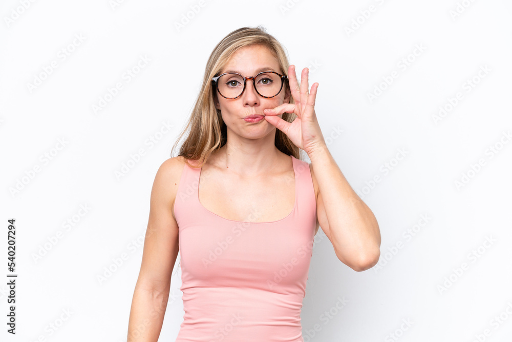 Young caucasian woman isolated on white background showing a sign of silence gesture Young caucasian woman isolated on white background showing a sign of silence gesture