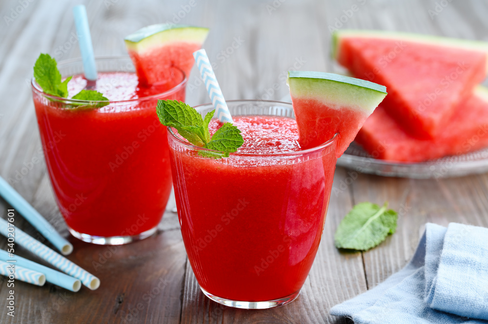 Watermelon smoothie in glasses with mint. Freshly squeezed juice. Refreshing summer drink. Vegetarian healthy food. Selective focus Watermelon smoothie in glasses with mint. Freshly squeezed juice. Refreshing summer drink. Vegetarian healthy food. Selective focus