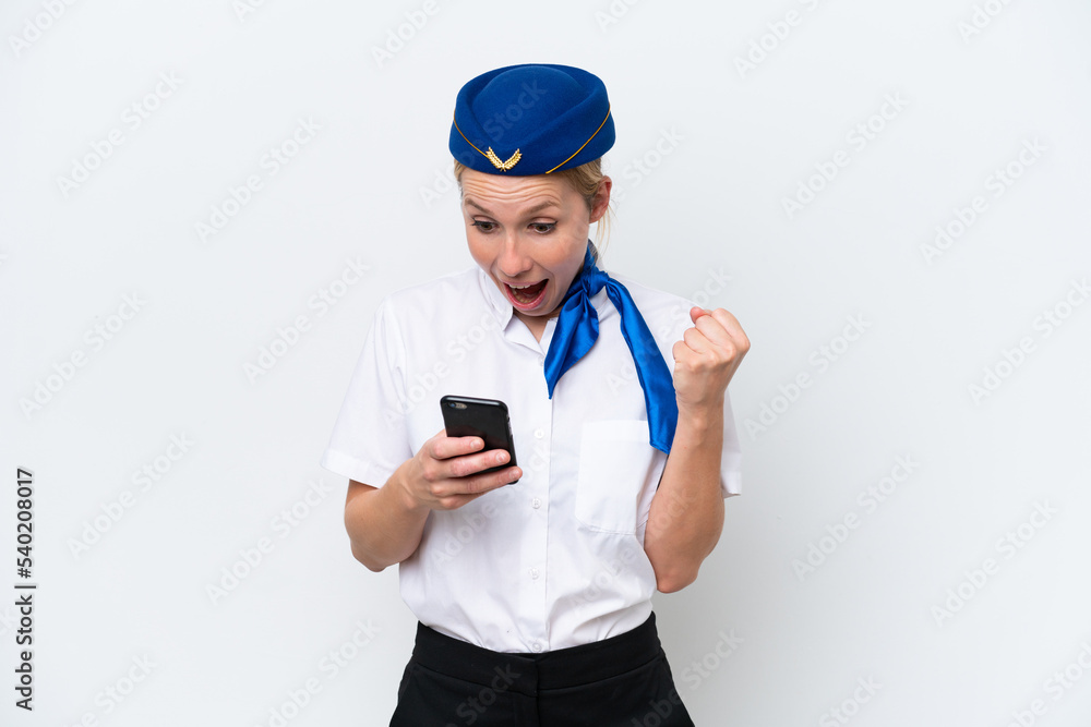 Airplane blonde stewardess woman isolated on white background surprised and sending a message Airplane blonde stewardess woman isolated on white background surprised and sending a message