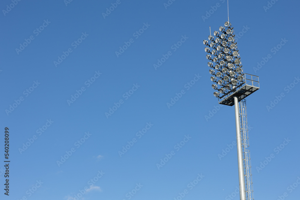Sports stadium lighting system. The lights of a football stadium, are not in use. Light tower with many luminous projectors to illuminate the night sports event at the stadium. Sports stadium lighting system. The lights of a football stadium, are not in use. Light tower with many luminous projectors to illuminate the night sports event at the stadium.