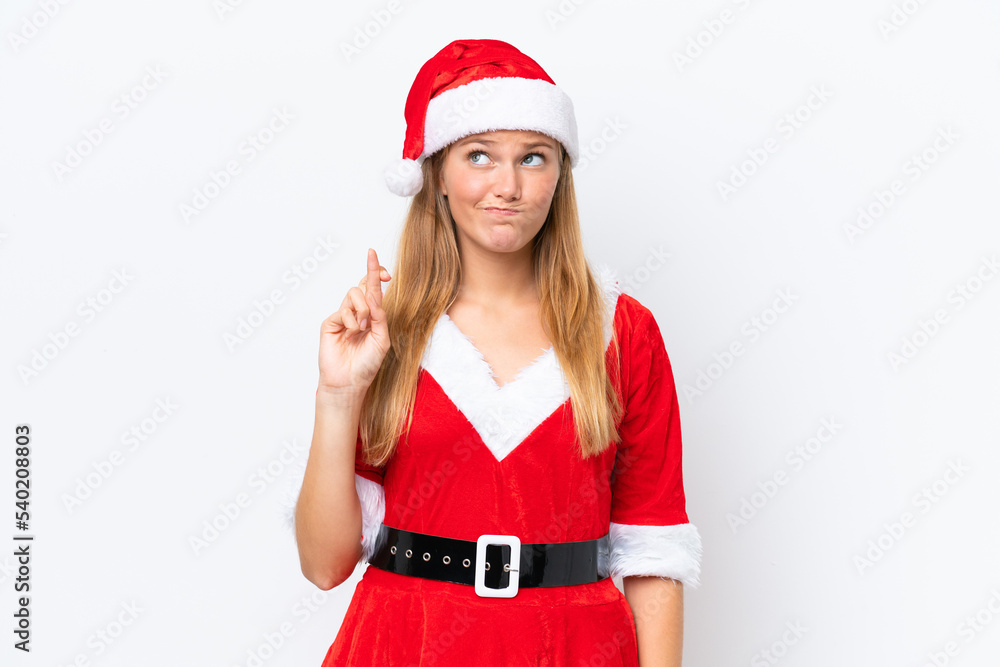 Young caucasian woman dressed as mama noel isolated on white background with fingers crossing and wishing the best Young caucasian woman dressed as mama noel isolated on white background with fingers crossing and wishing the best