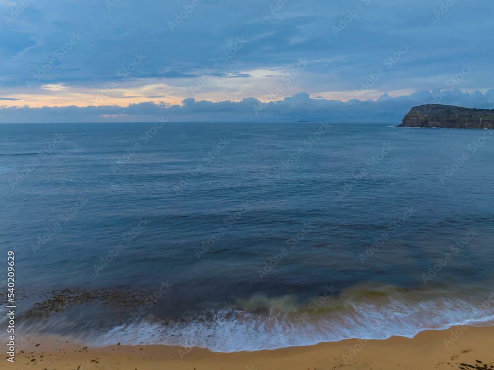 Pastel cloud covered sunrise seascape Pastel cloud covered sunrise seascape