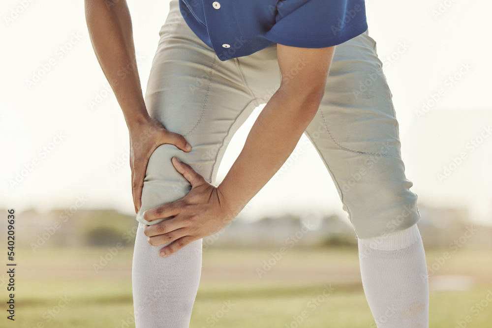 Sports man, knee injury and athlete with leg muscle strain on baseball field ground of pitch at athletic training ball game. Exercise accident, joint pain and outdoor fitness workout in Dallas Texas Sports man, knee injury and athlete with leg muscle strain on baseball field ground of pitch at athletic training ball game. Exercise accident, joint pain and outdoor fitness workout in Dallas Texas