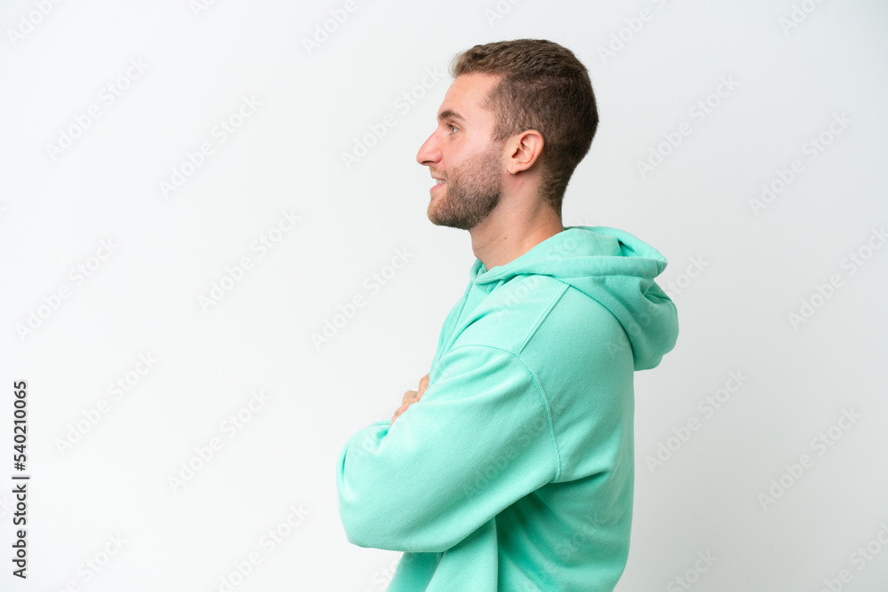 Young handsome caucasian man isolated on white background in lateral position Young handsome caucasian man isolated on white background in lateral position