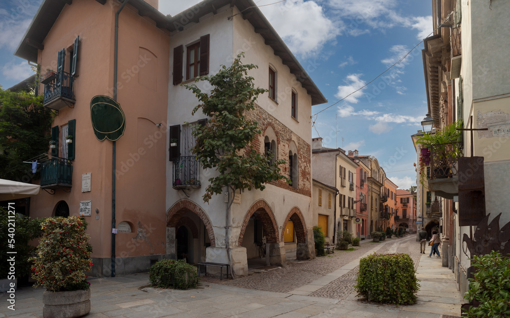 Cuneo, Piedmont, Italy - October 14, 2022: Contrada Mondovì, ancient street in the historic center with medieval and nineteenth-century buildings at sunset
