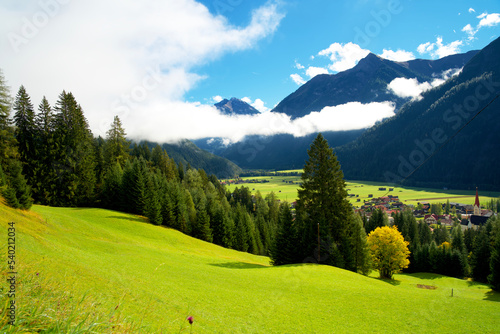 Mountain landscape of lech valley in autumn with green, yellow and golden colors during indian summer, with blue sky