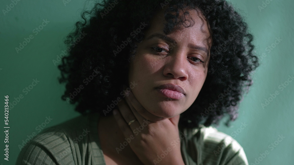 Thoughtful African American woman face thinking. A pensive black girl leaning on wall hand in chin pondering solution Thoughtful African American woman face thinking. A pensive black girl leaning on wall hand in chin pondering solution