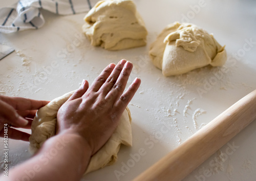 African American woman, Black woman female hands kneading yeast dough, wooden French rolling pin, pizza, bread