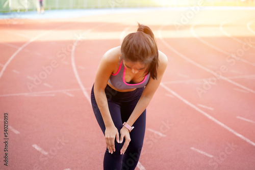Closeup image of a young woman showing a knee injury after the injury accident from workout.