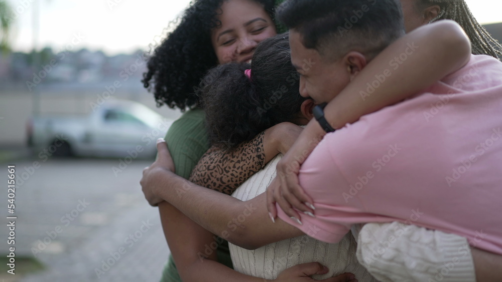 Happy Brazilian people hugging together. South American family embrace standing outdoors. Joyful group of hispanic friends smiling 3 Happy Brazilian people hugging together. South American family embrace standing outdoors. Joyful group of hispanic friends smiling 3