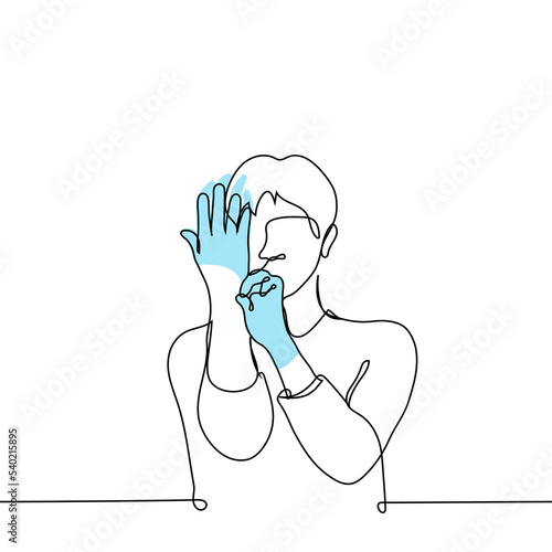 man puts disposable gloves on his hands - one line drawing vector. mesophobe concept, squeamish person