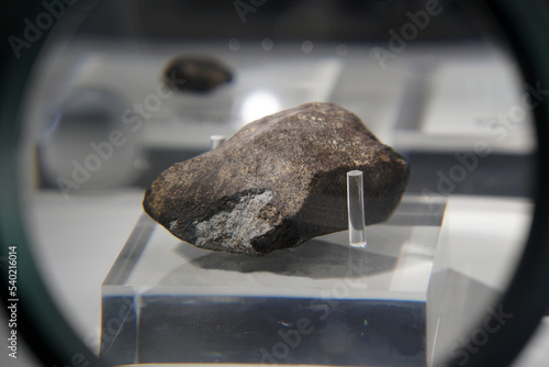 A sample piece of Chiang Khan chondrites meteorite stone. view through a magnifying glass. photo