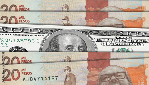 Colombian peso and US 100 bill. Close up Colombian banknotes and US banknotes. 