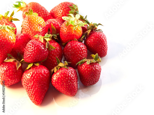 Fresh, red and delicious strawberries on a light background