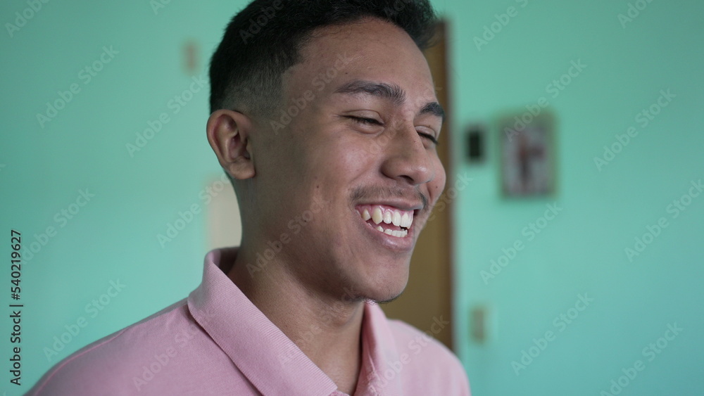 One happy hispanic young man. A hispanic latin south american person natural laugh and smile One happy hispanic young man. A hispanic latin south american person natural laugh and smile