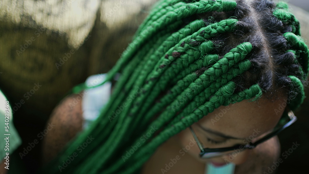 One young black latina woman with box braids green hairstyle