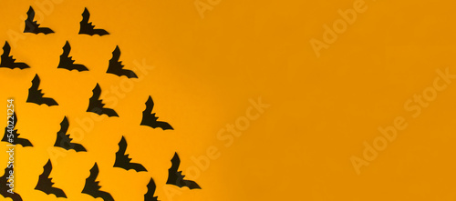 Poster with bats on orange background with copy space, empty for text. The concept of invitation, congratulations, holiday, party, promotions, postcard, layout, mock-up, template. High quality photo © Anna