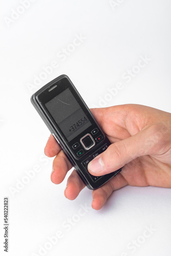 Wallpaper Mural hand holding a vintage mobile phone isolated on white background Torontodigital.ca